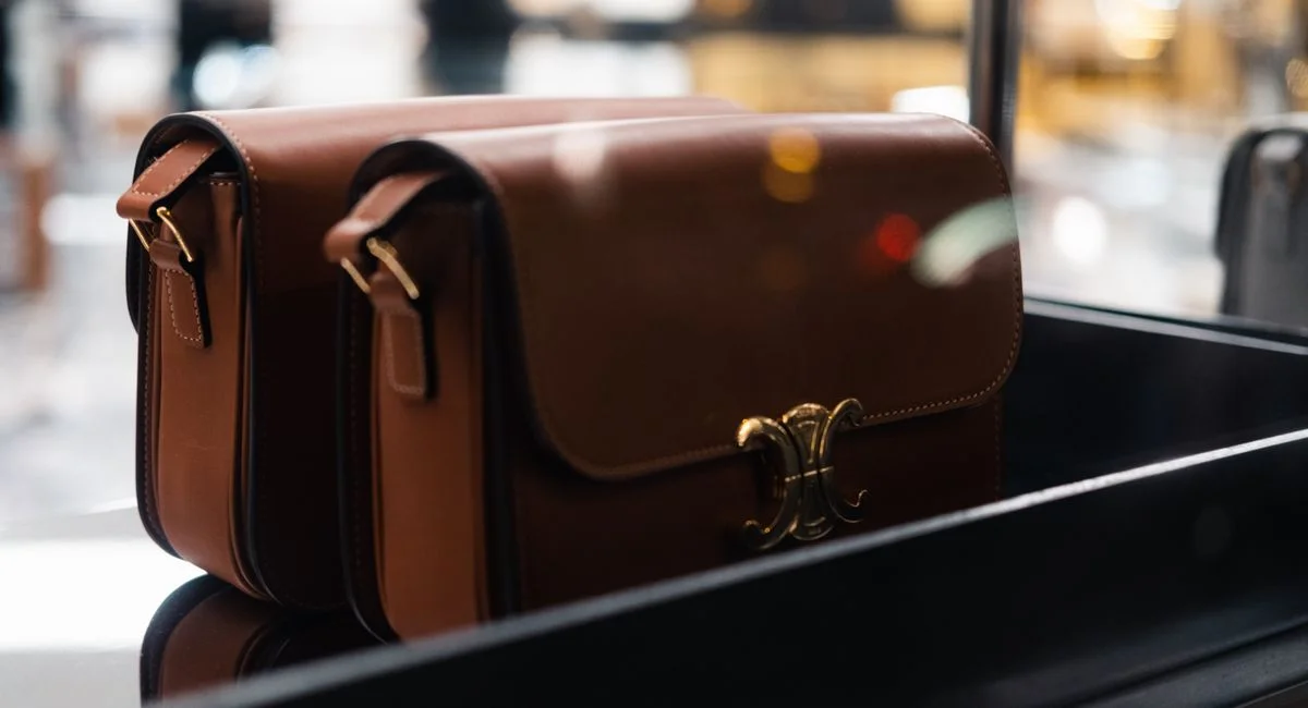 Stylish brown leather handbags showcased indoors with soft focus lights.